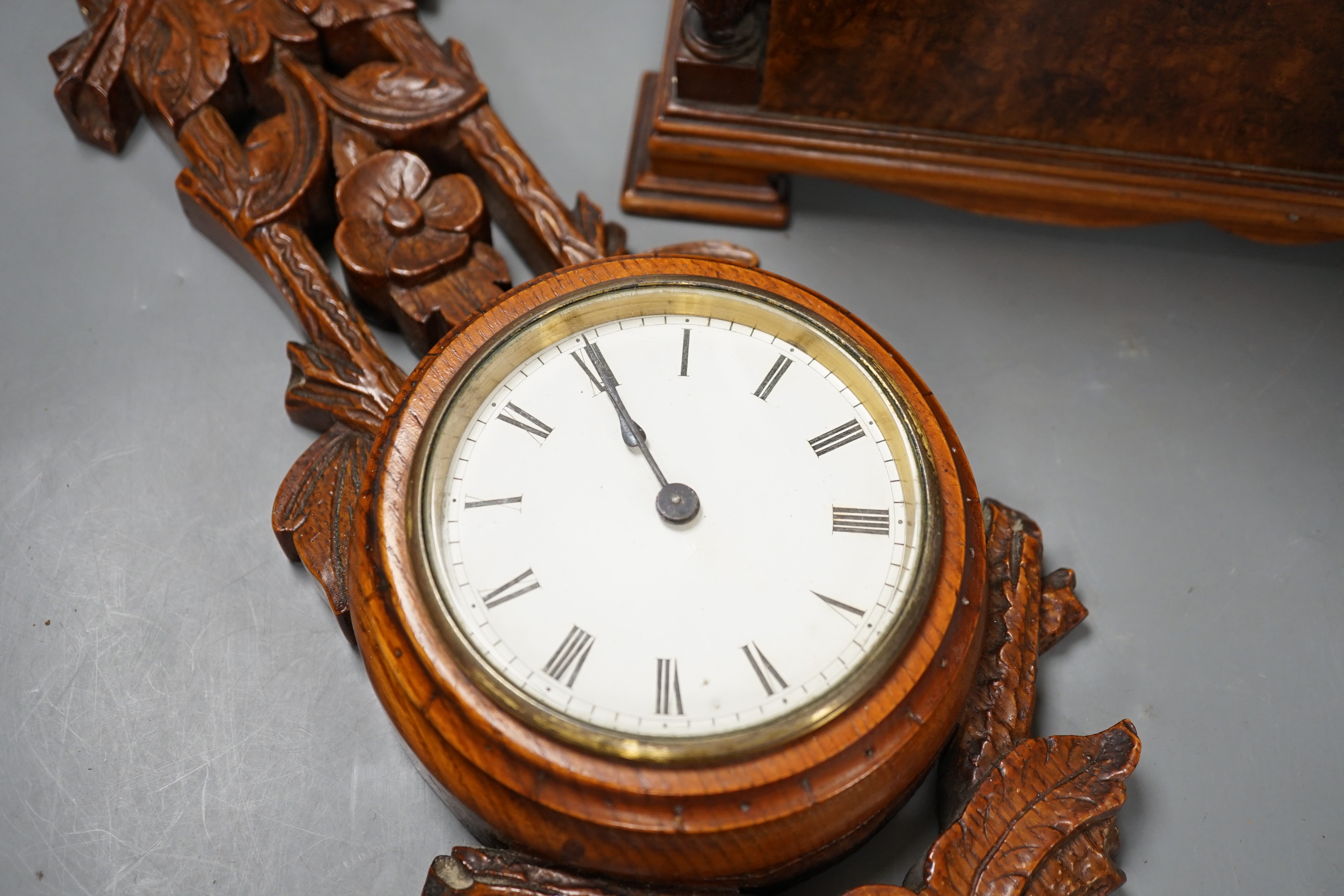 A Victorian carved oak wall timepiece and a burr walnut mantel clock